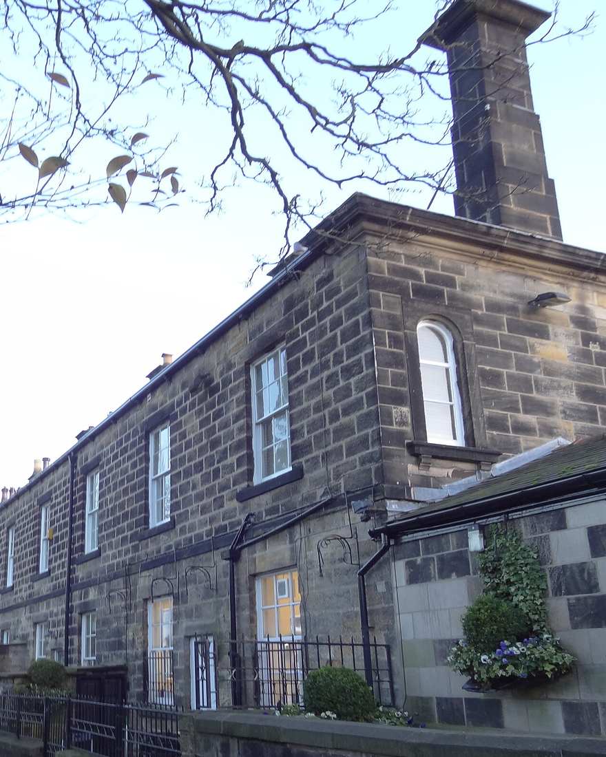Tall stone chimney stack above the slate roof of a Leeds terrace